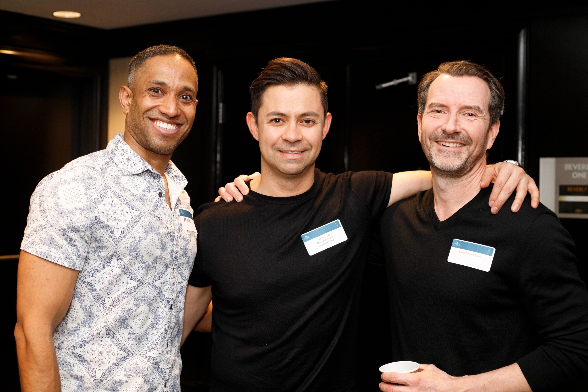 Three attendees connecting at a chamber gathering