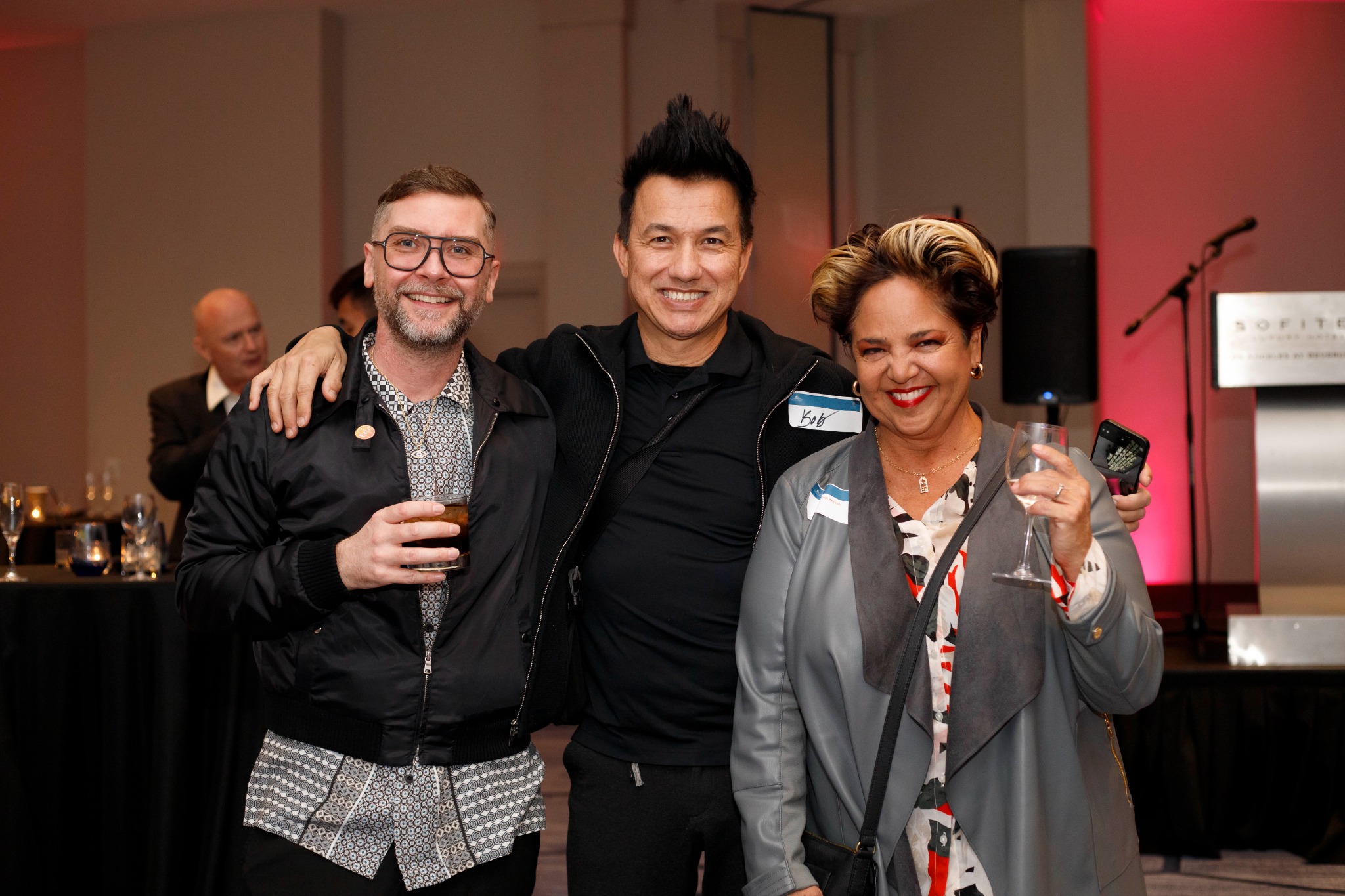 Three guests celebrating together at a chamber event