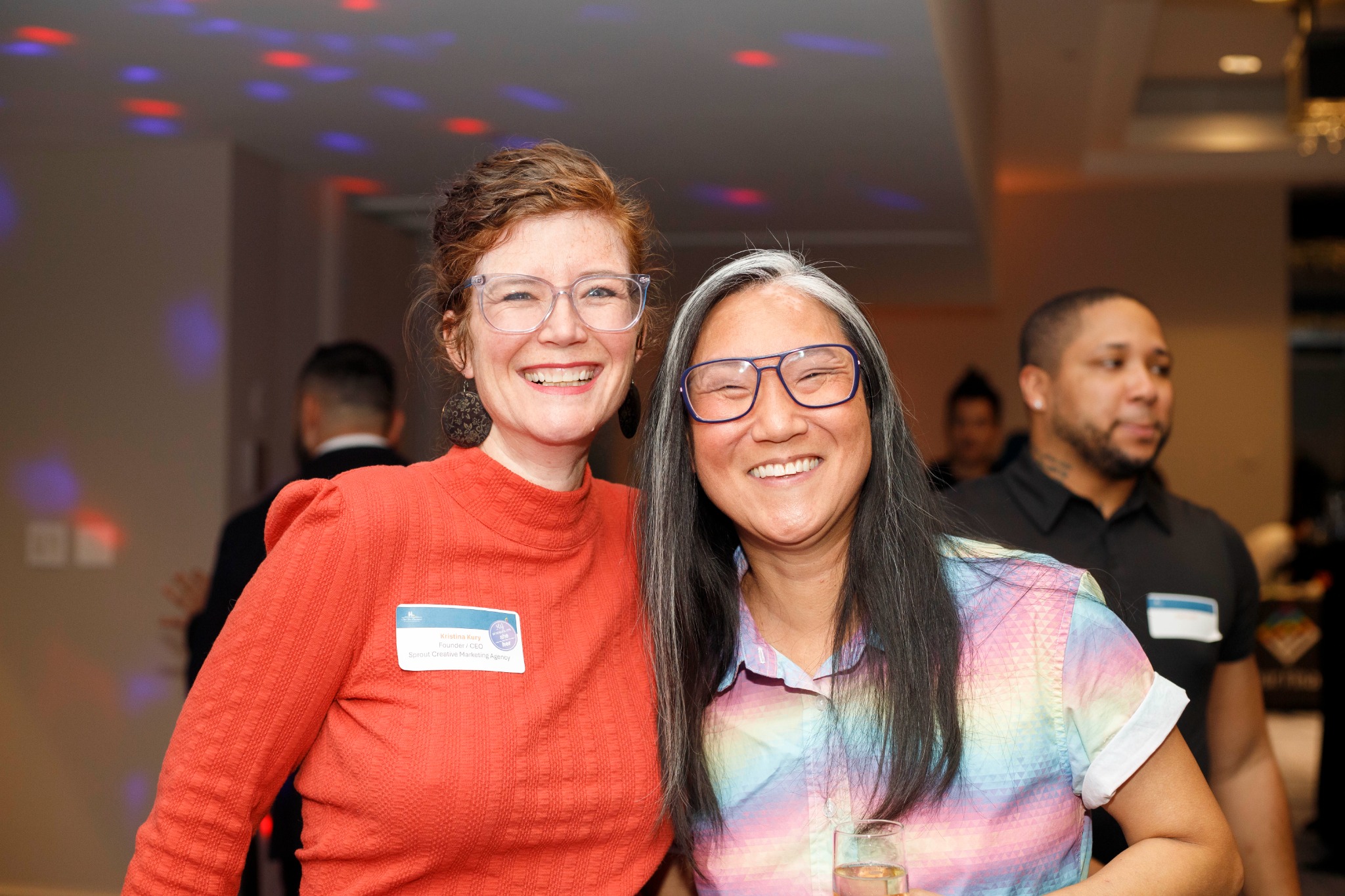 Two guests smiling together at a chamber event