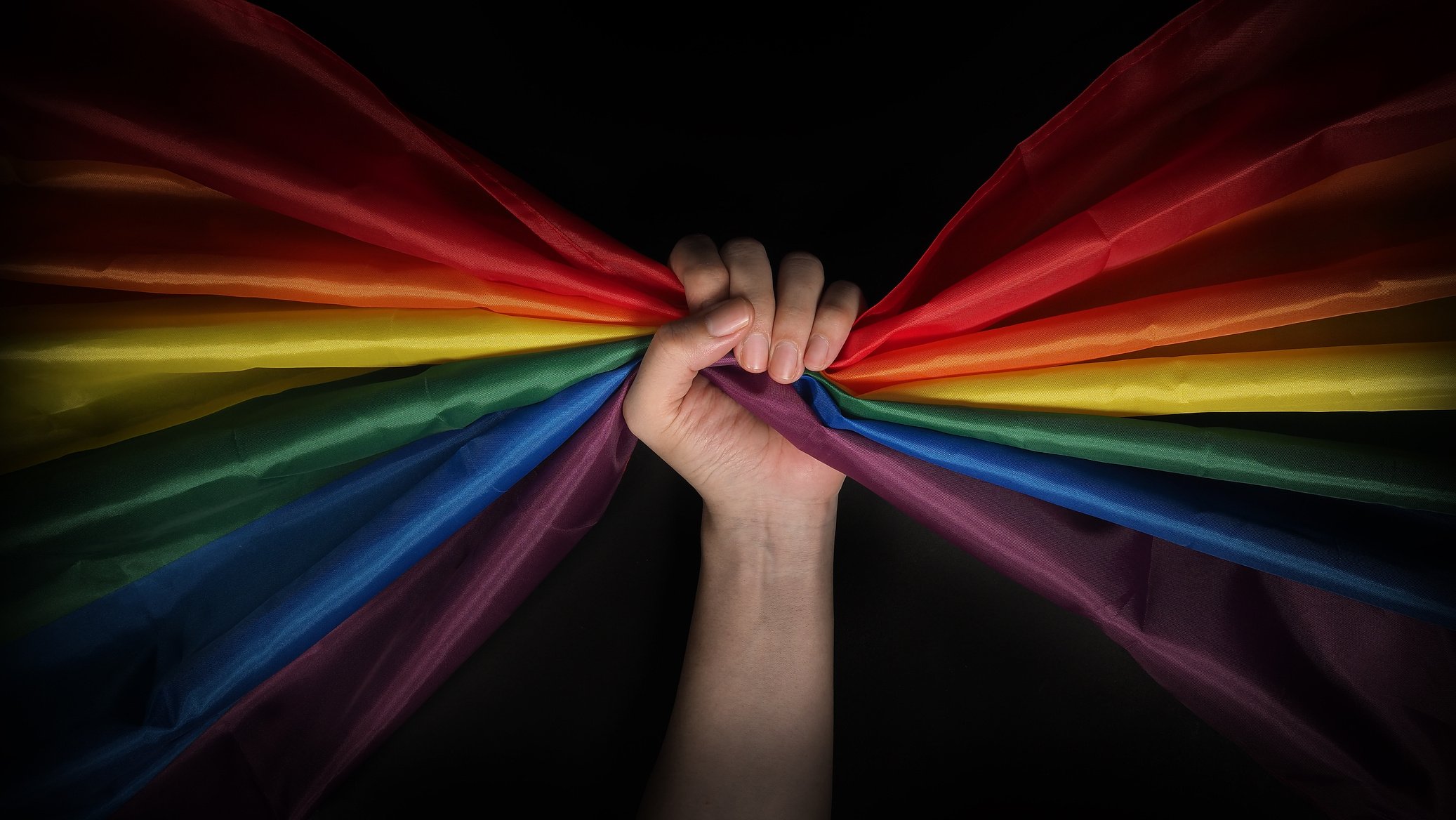 Hand Holding a LGBTQ Pride Flag